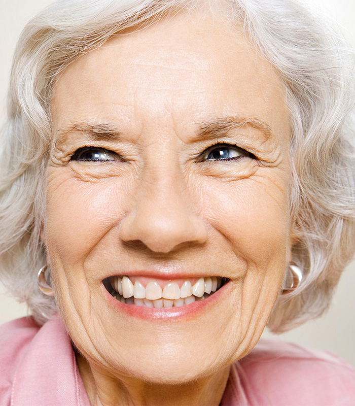A senior woman smiling.
