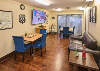 The game room at Arbor Place Residential with a TV and chairs